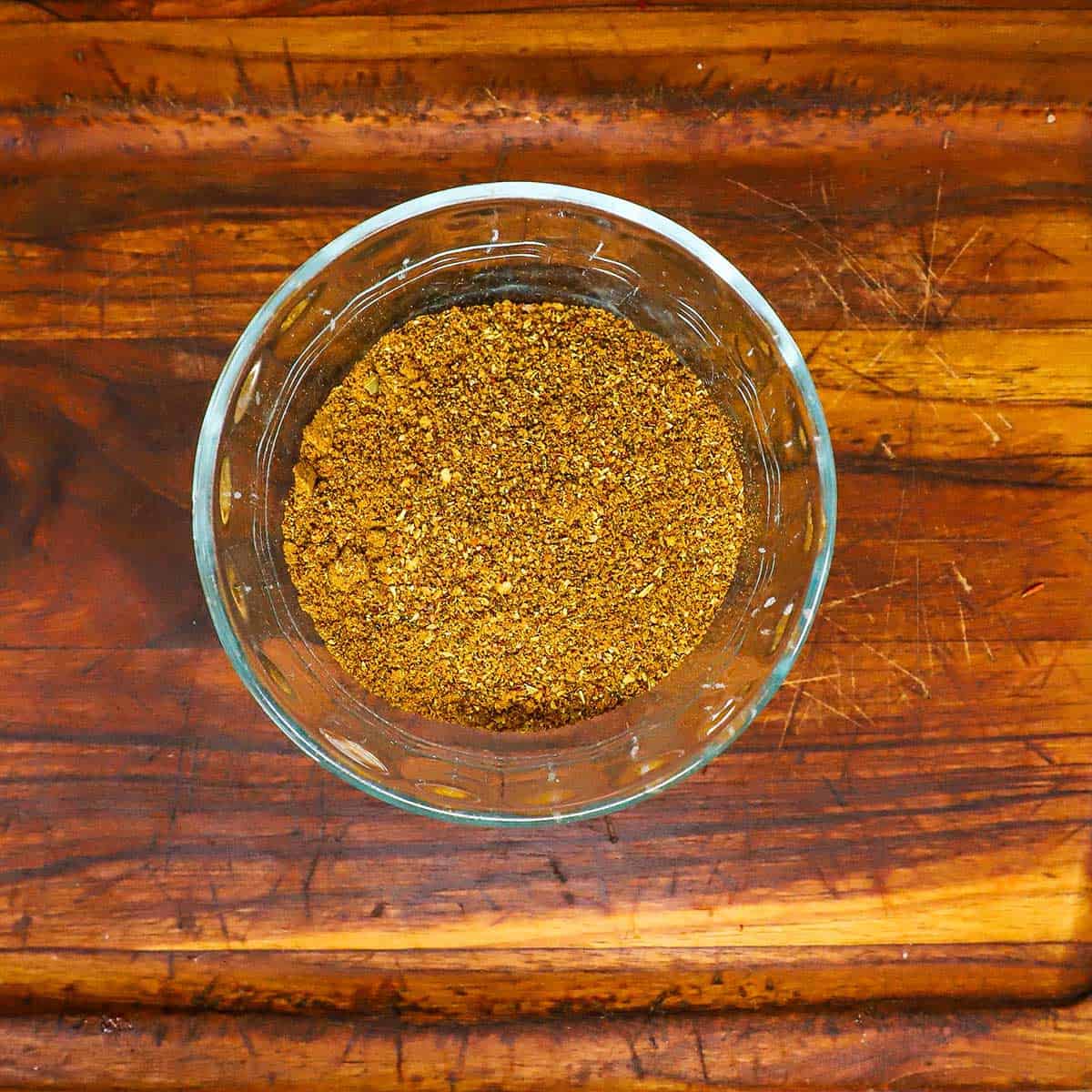 An overhead view of a small bowl filled with freshly prepared Biryani Masala.