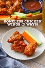 A small white cocktail plate with three boneless chicken wings and a stalk of celery and carrot all resting on it.