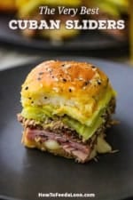 A single melty Cuban slider sitting on a black dinner plate.