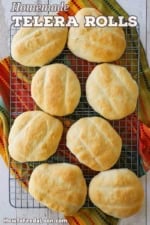 An overhead view of a baking rack topped with freshly baked homemade telera rolls.